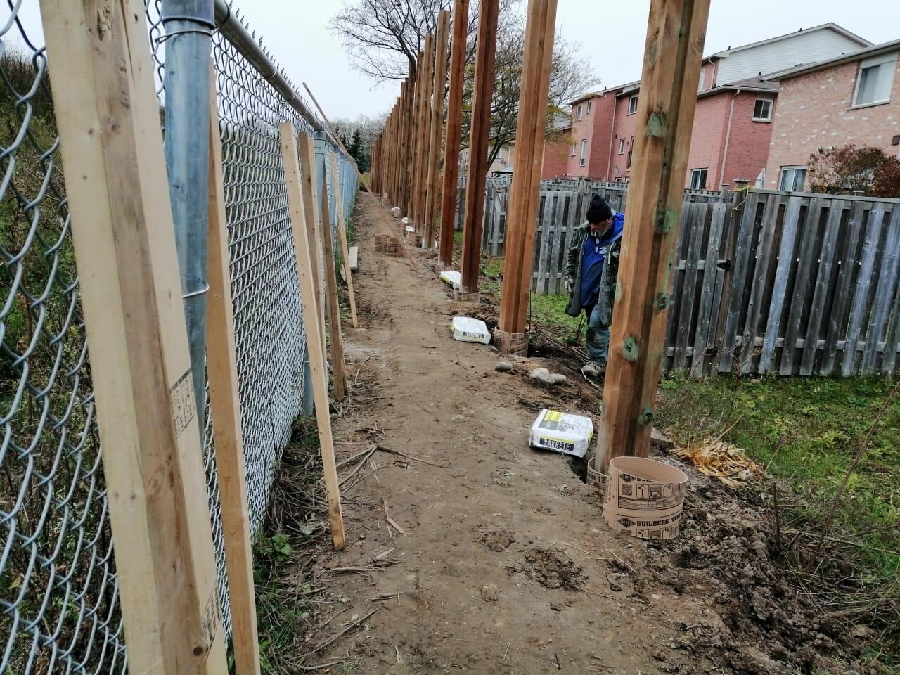 Backyard fence line before replacement by Ramirez Landscaping in the Greater Toronto Area