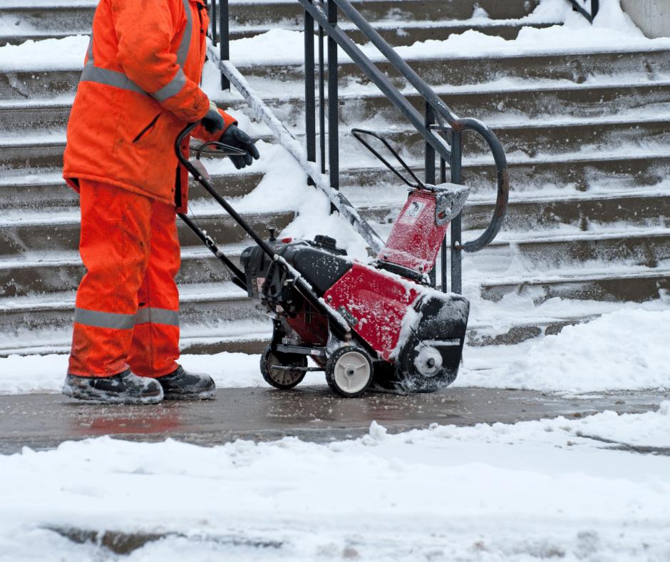 Snow blower clearing commercial stairs and walkway