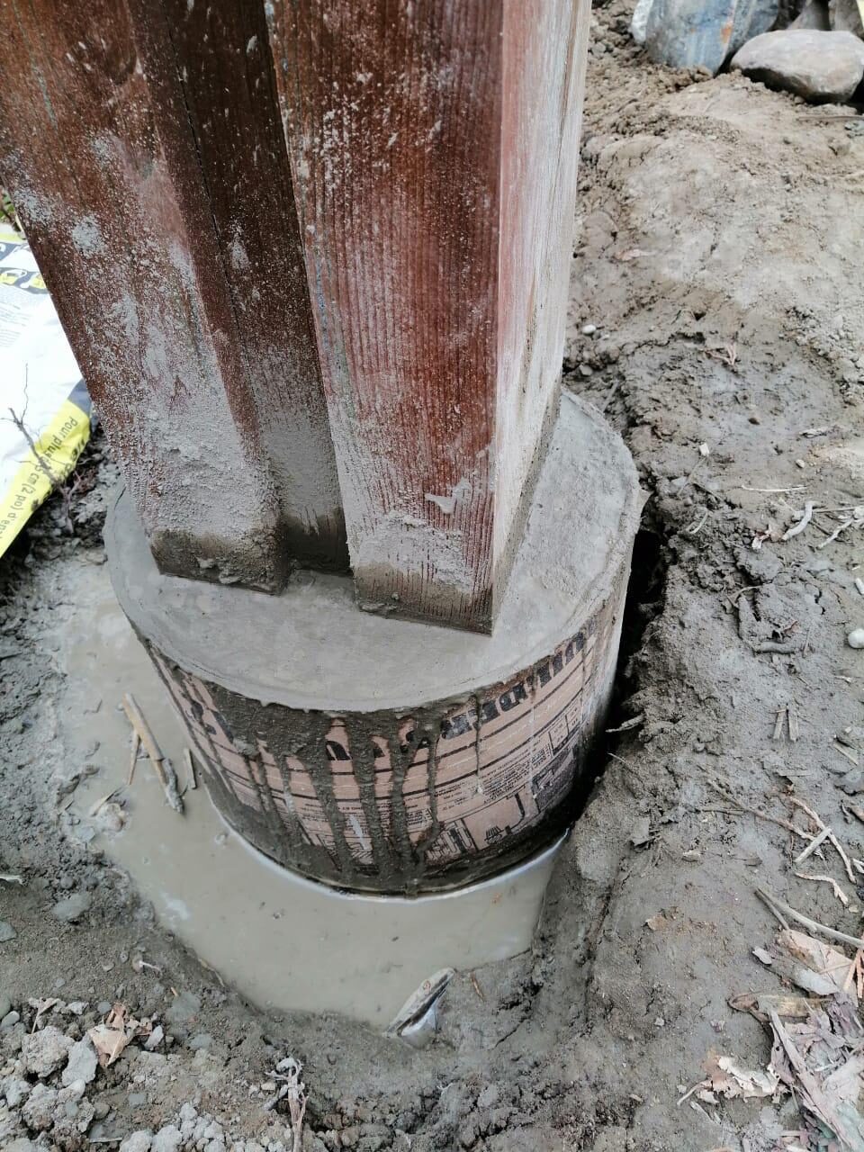 Crew setting pressure-treated fence posts during a wood fence installation in Toronto, ON